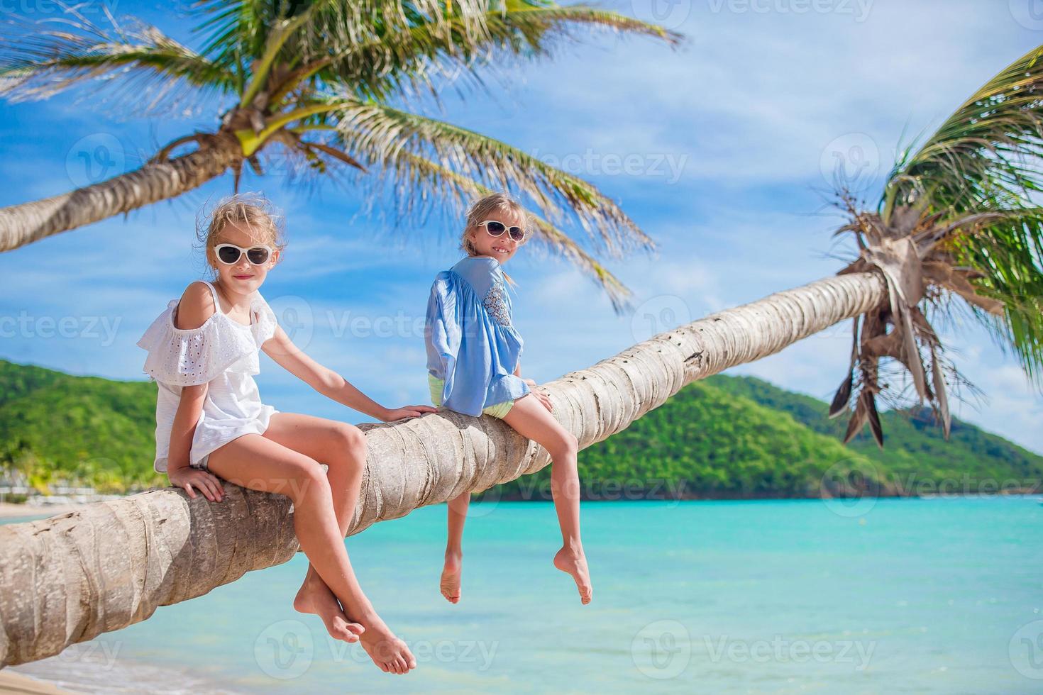 Adorable little kid having fun at beach during summer vacation photo
