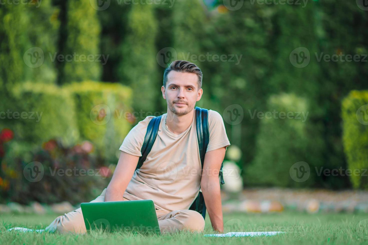 Young man hiking smiling happy portrait. Male hiker walking in the city photo