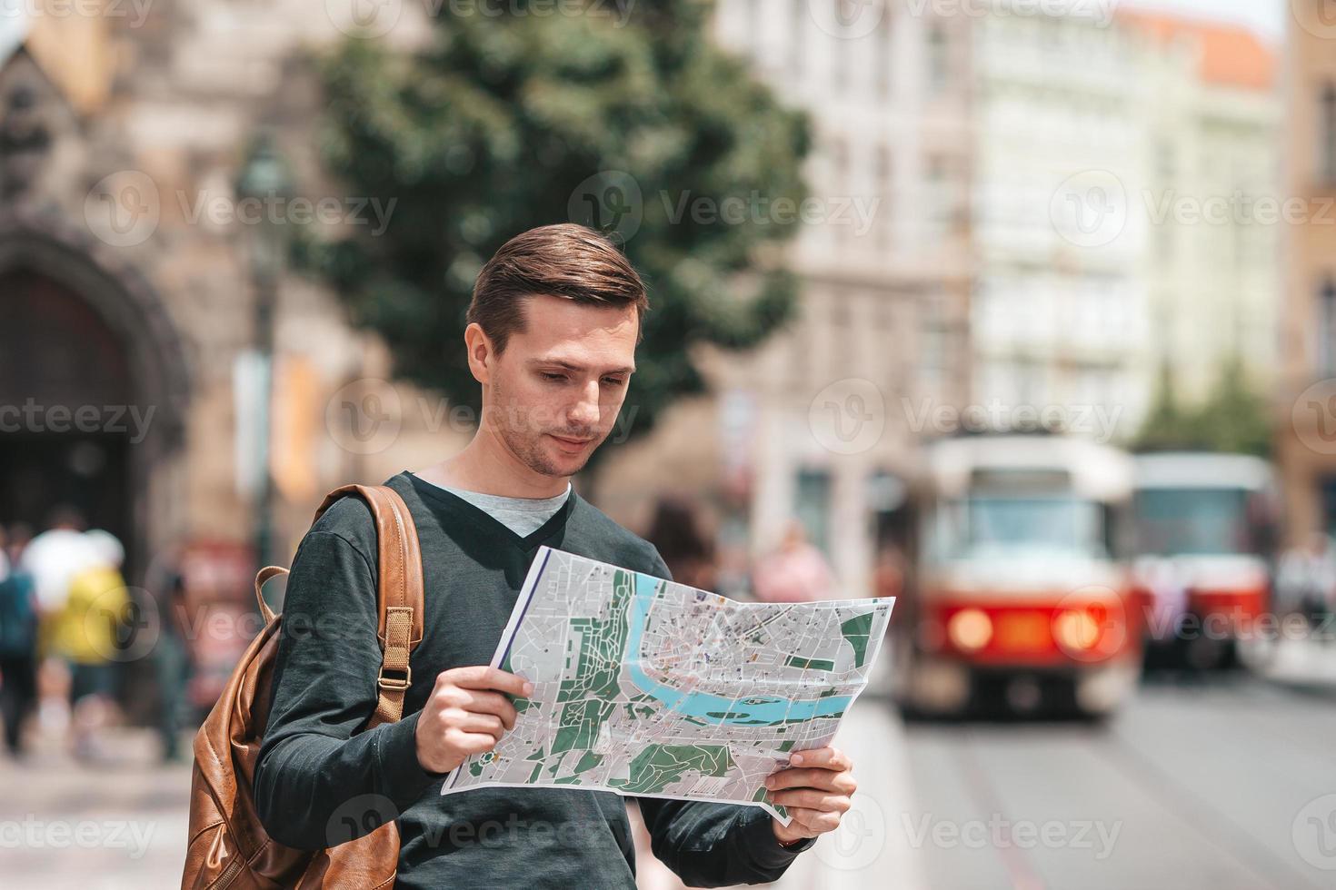 Carefree young man searching for place of destination photo