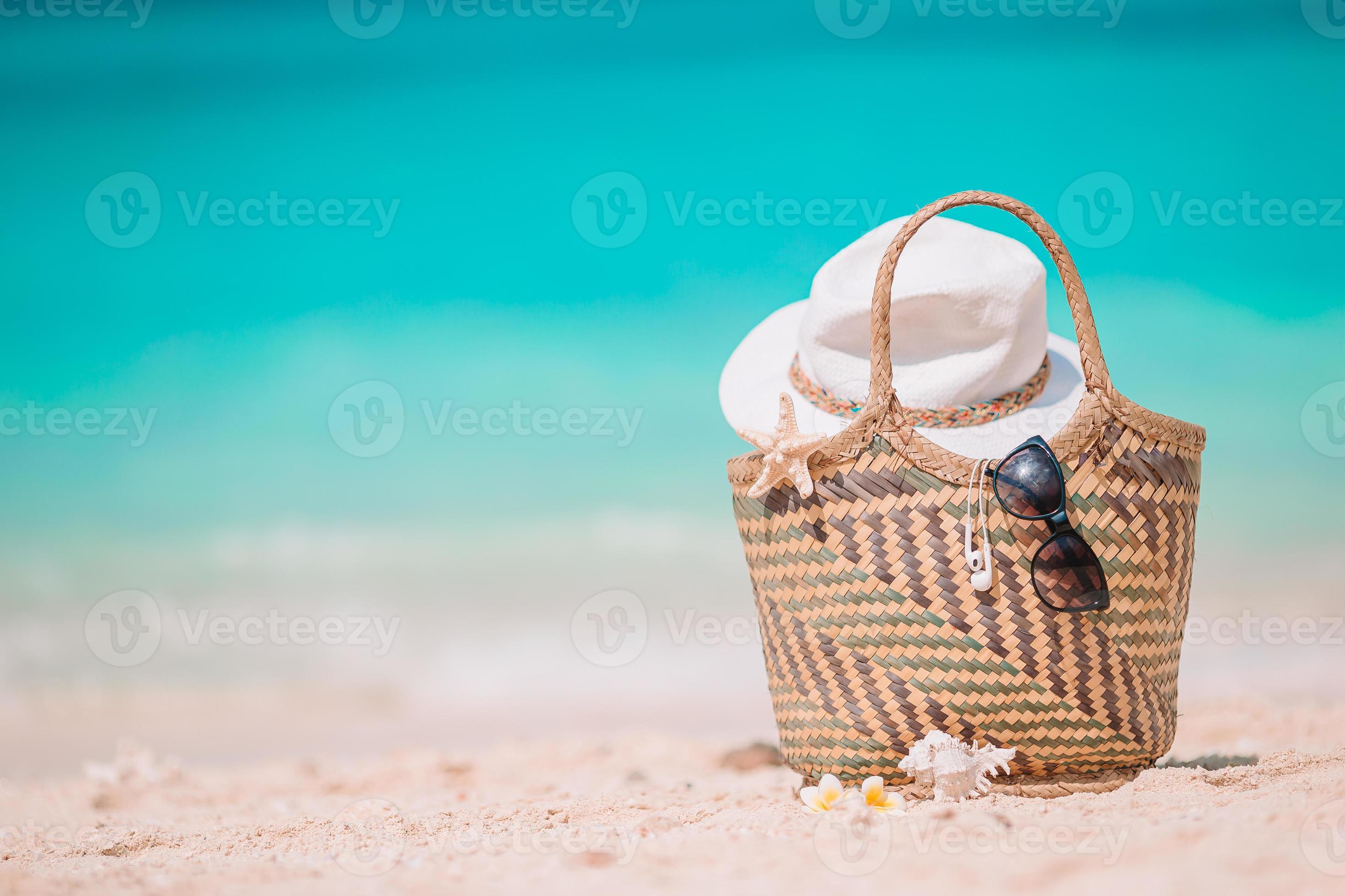 Beach accessories straw bag, hat and unglasses on the beach 18109192