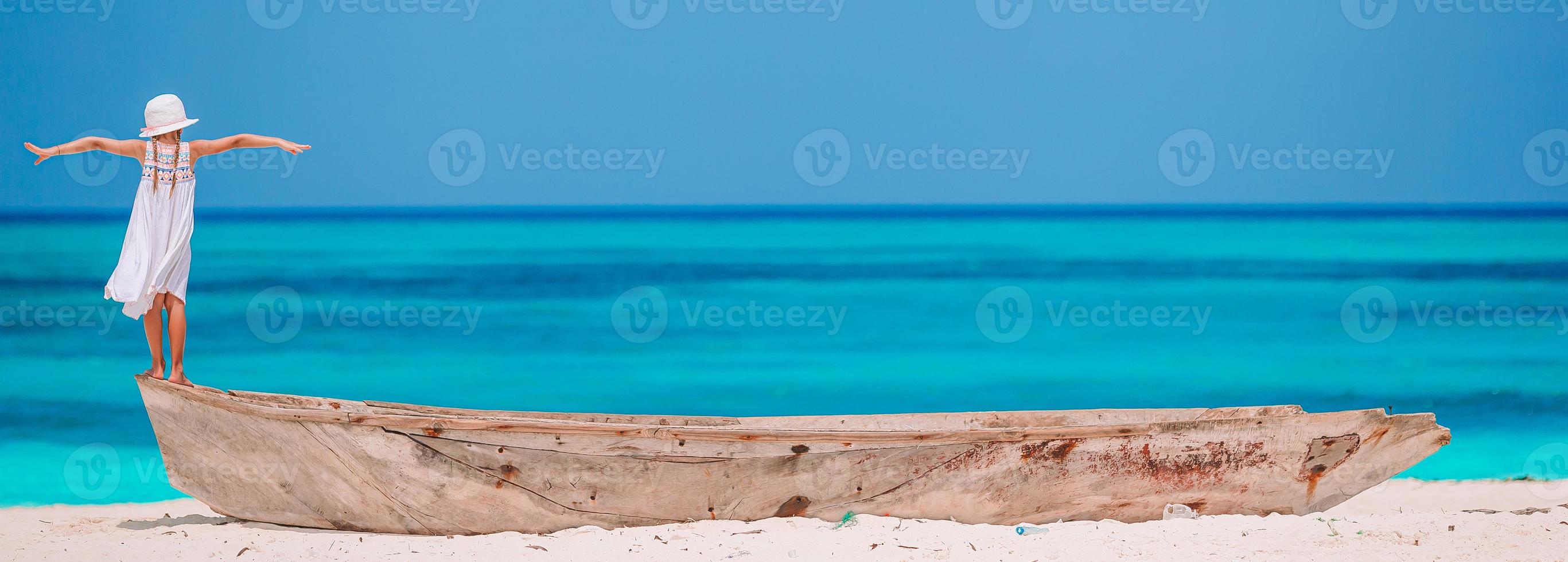 Cute little girl at beach during summer vacation photo