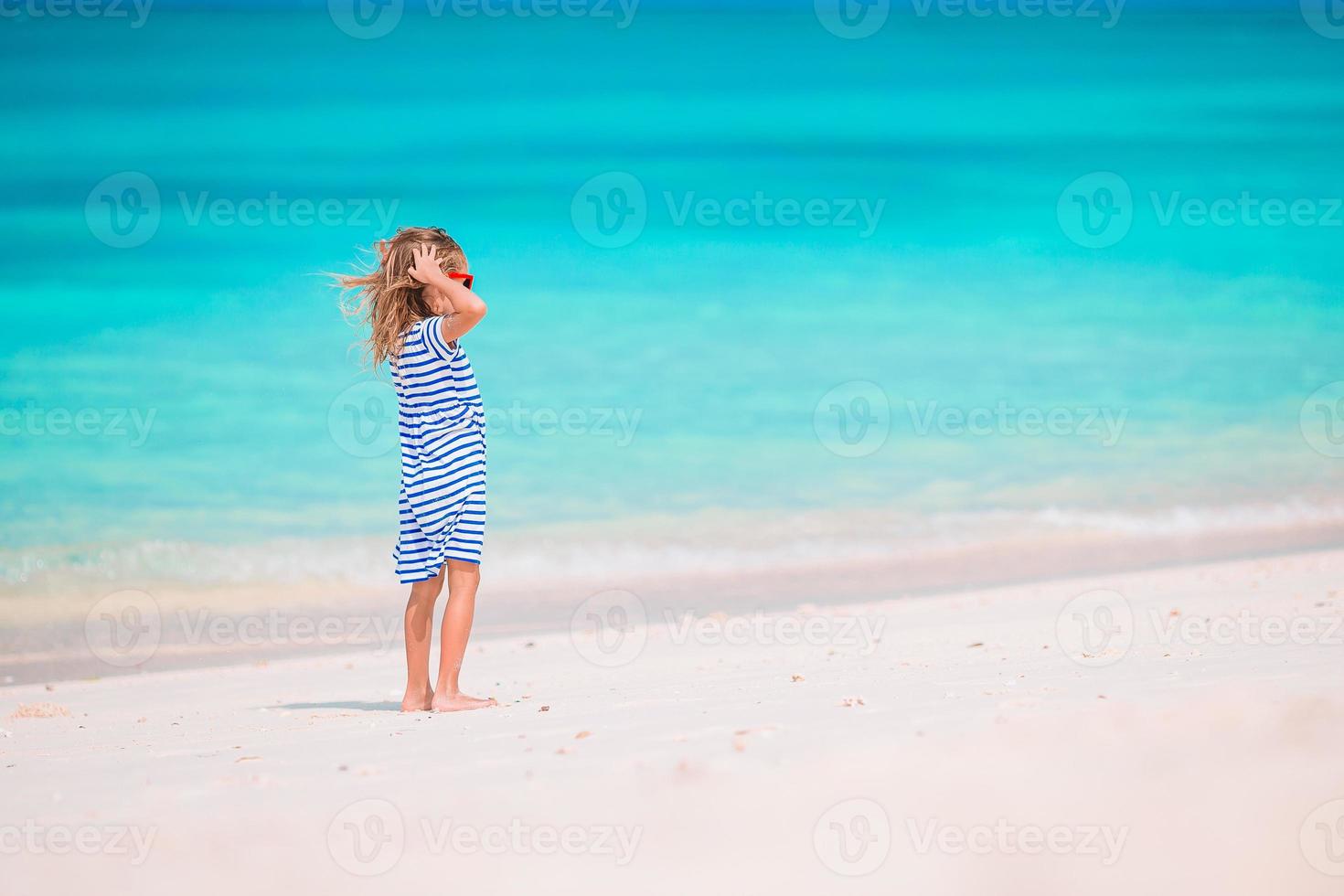 Adorable little girl at beach on her summer vacation photo