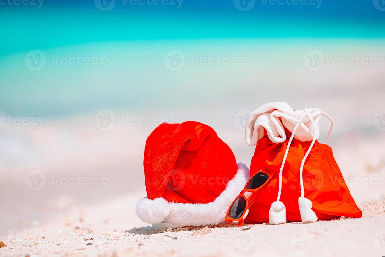 accessories with Santa Hat on white tropical beach photo