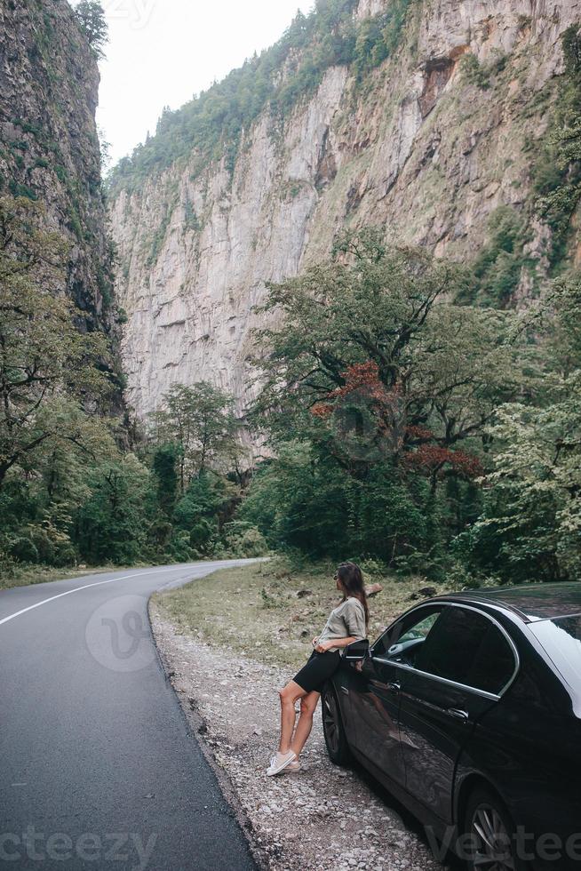 Travel concept. Young beautiful hipster woman travel by car photo