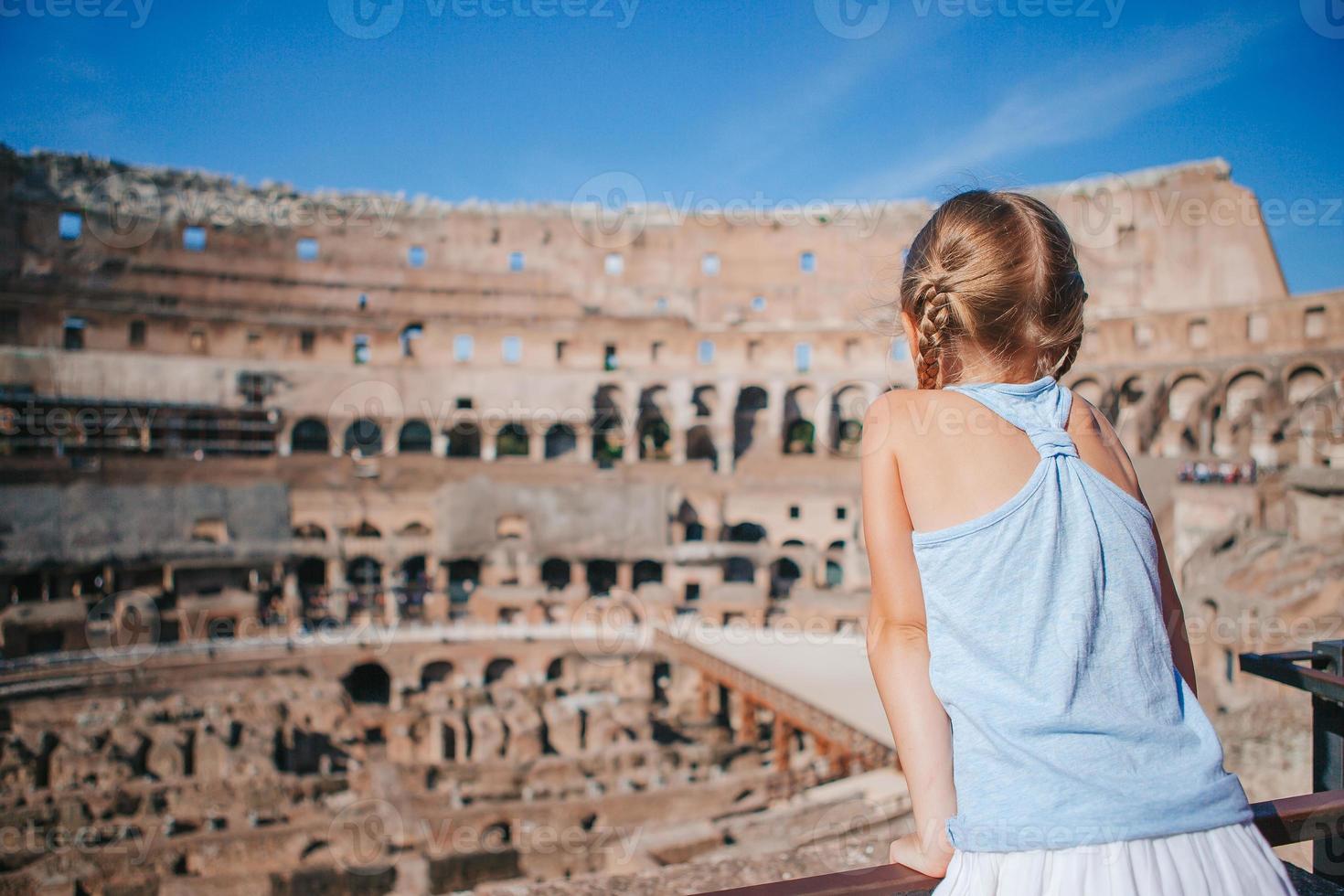 Happy toddler girl in Rome over Coliseum background photo