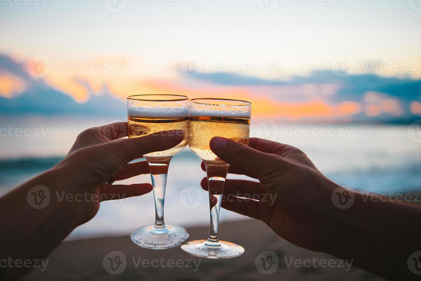 two glasses on the white sandy beach photo