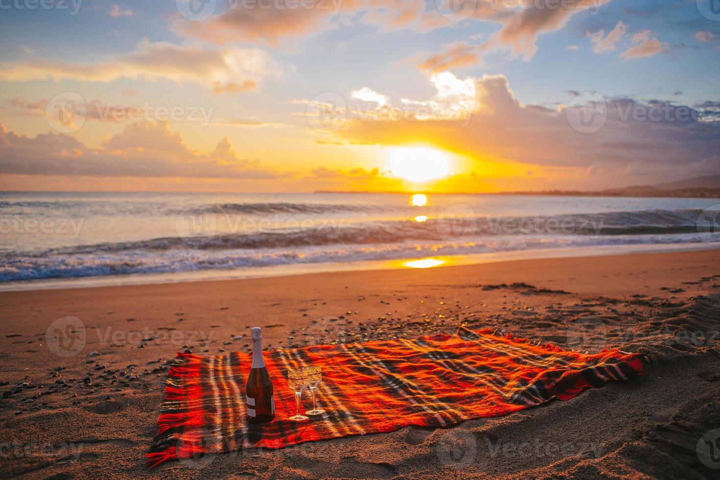 Having a picnic on the beach at sunset photo