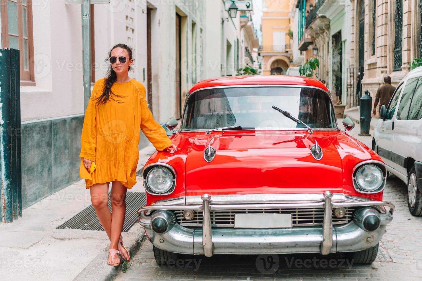 Tourist girl in popular area in Havana, Cuba. Back view of young woman traveler photo