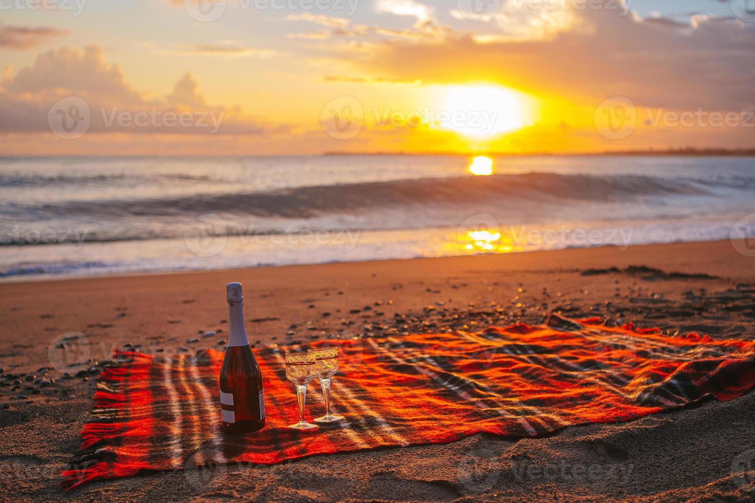 Having a picnic on the beach at sunset photo