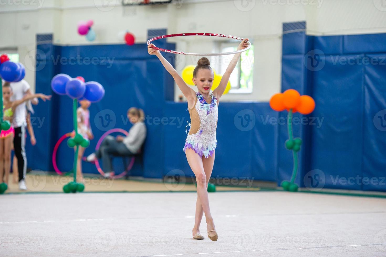 Little gymnast training on the carpet and ready for competitions photo