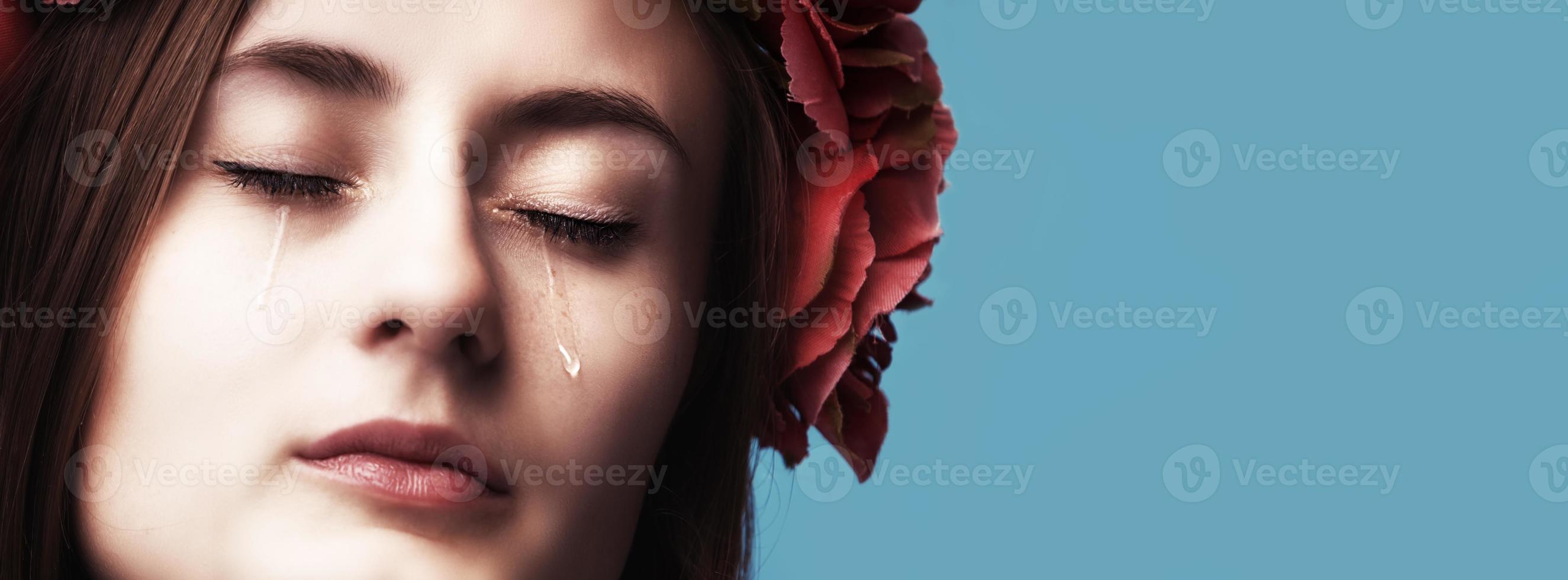 Portrait of young beautiful woman crying photo