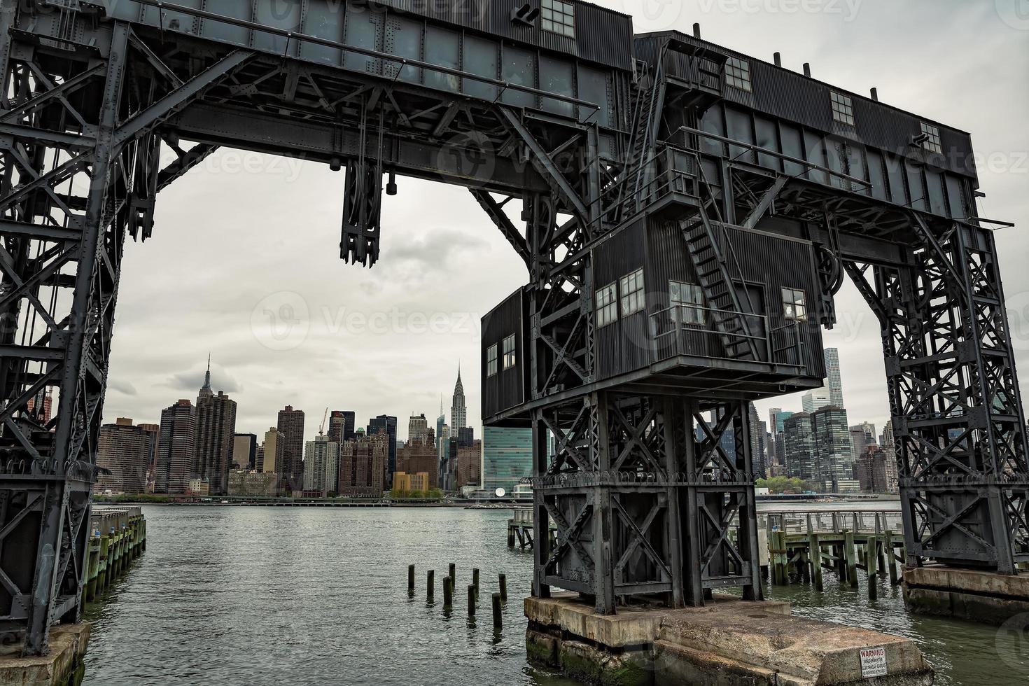 Abandoned gantry with city view behind. photo