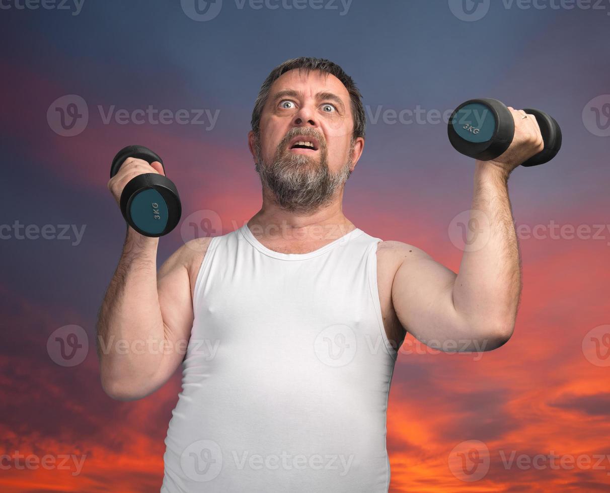 man exercising with dumbbells photo