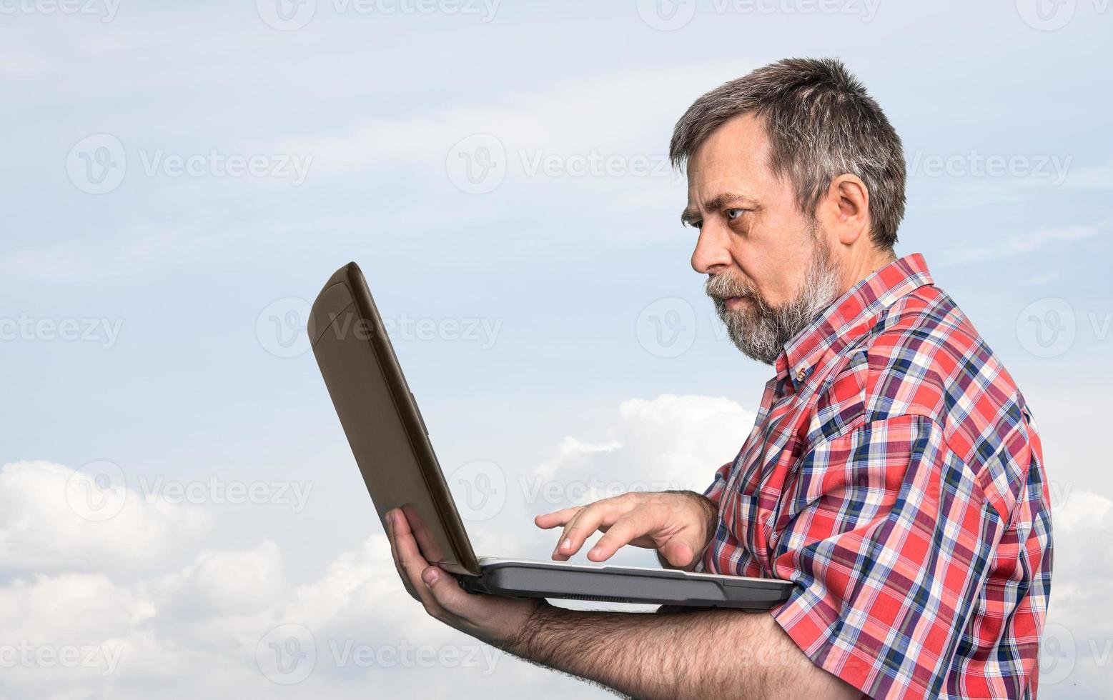 businessman holding laptop photo