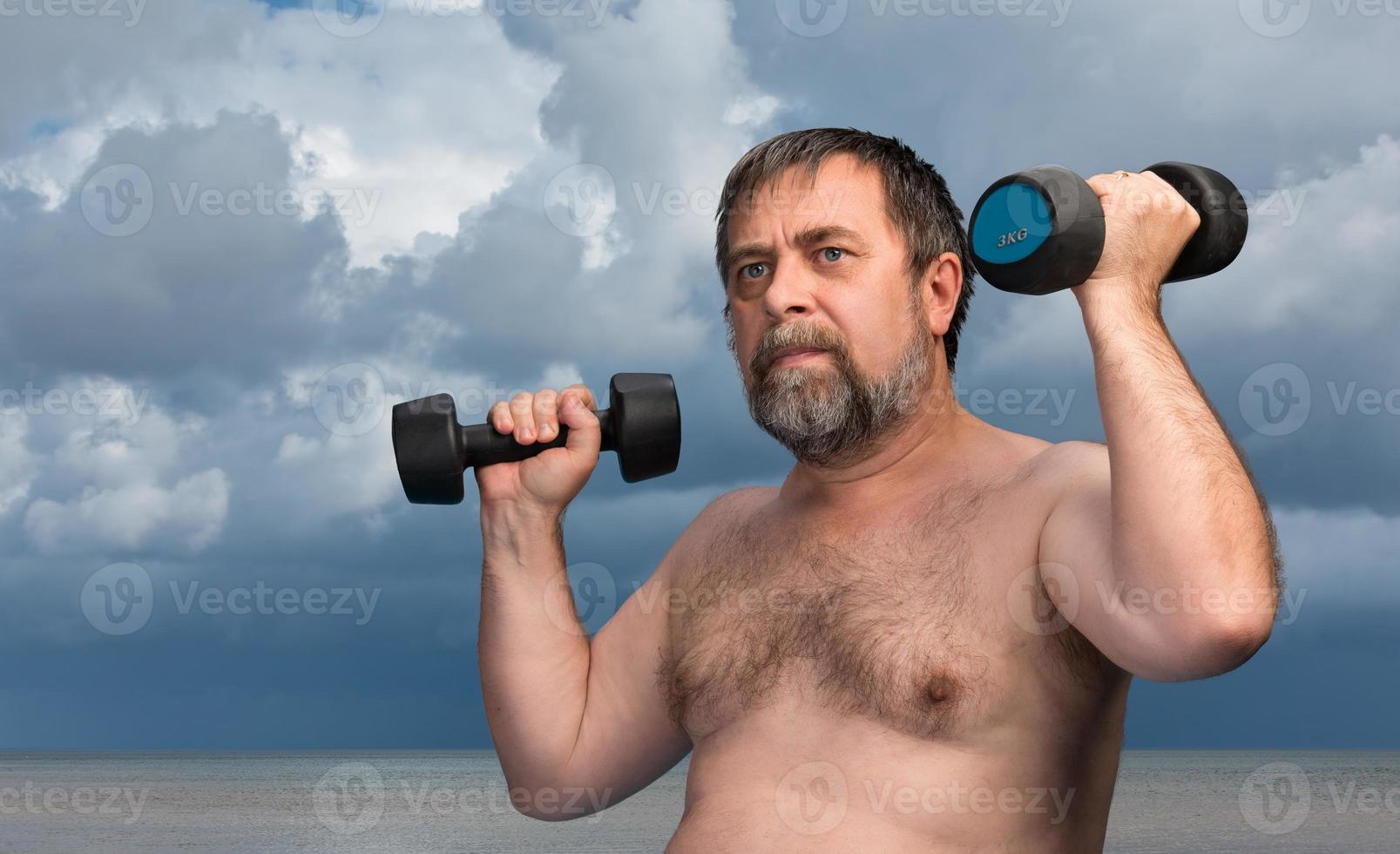 man exercising with dumbbells photo