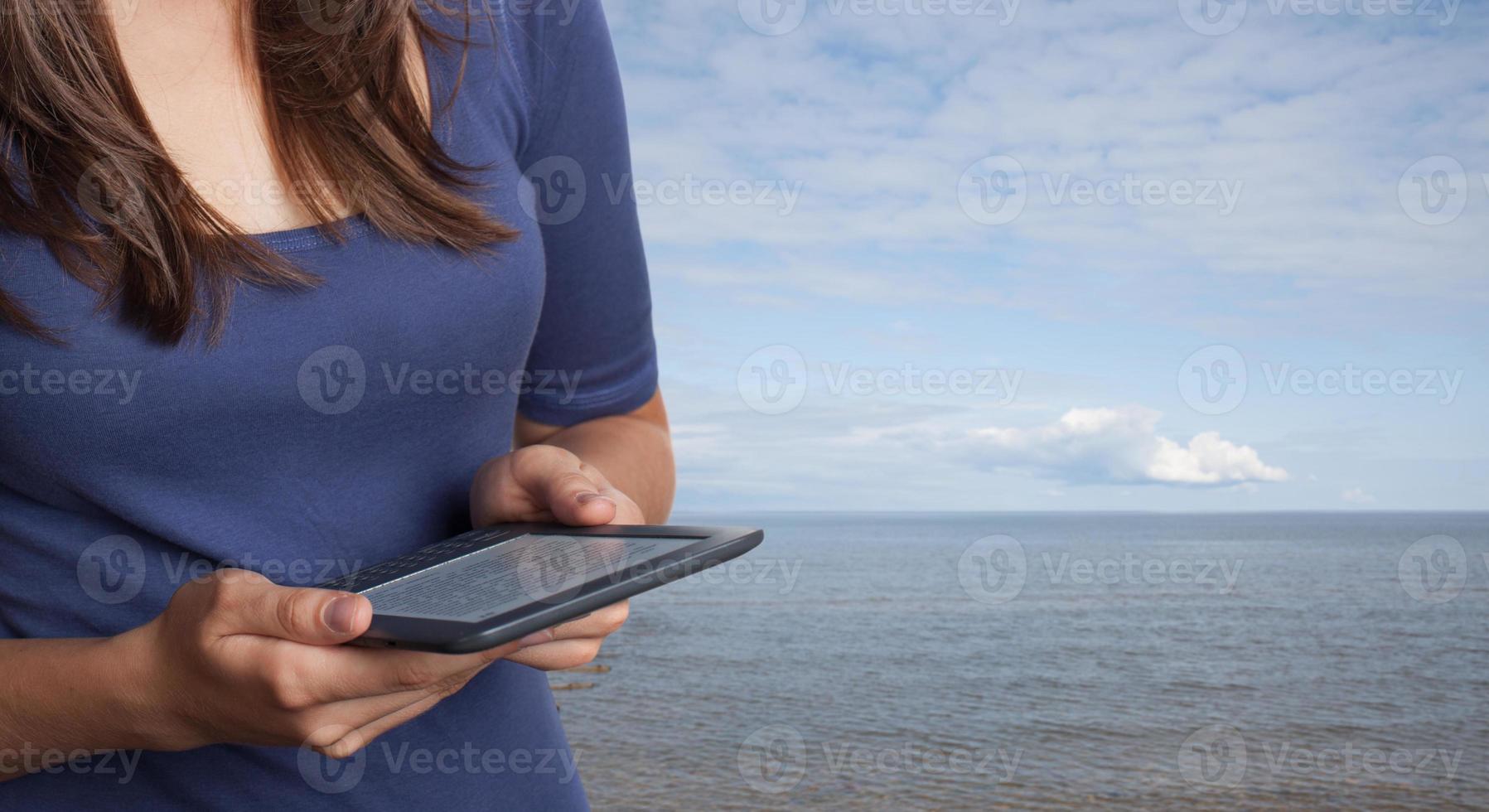 Young woman reading ebook photo