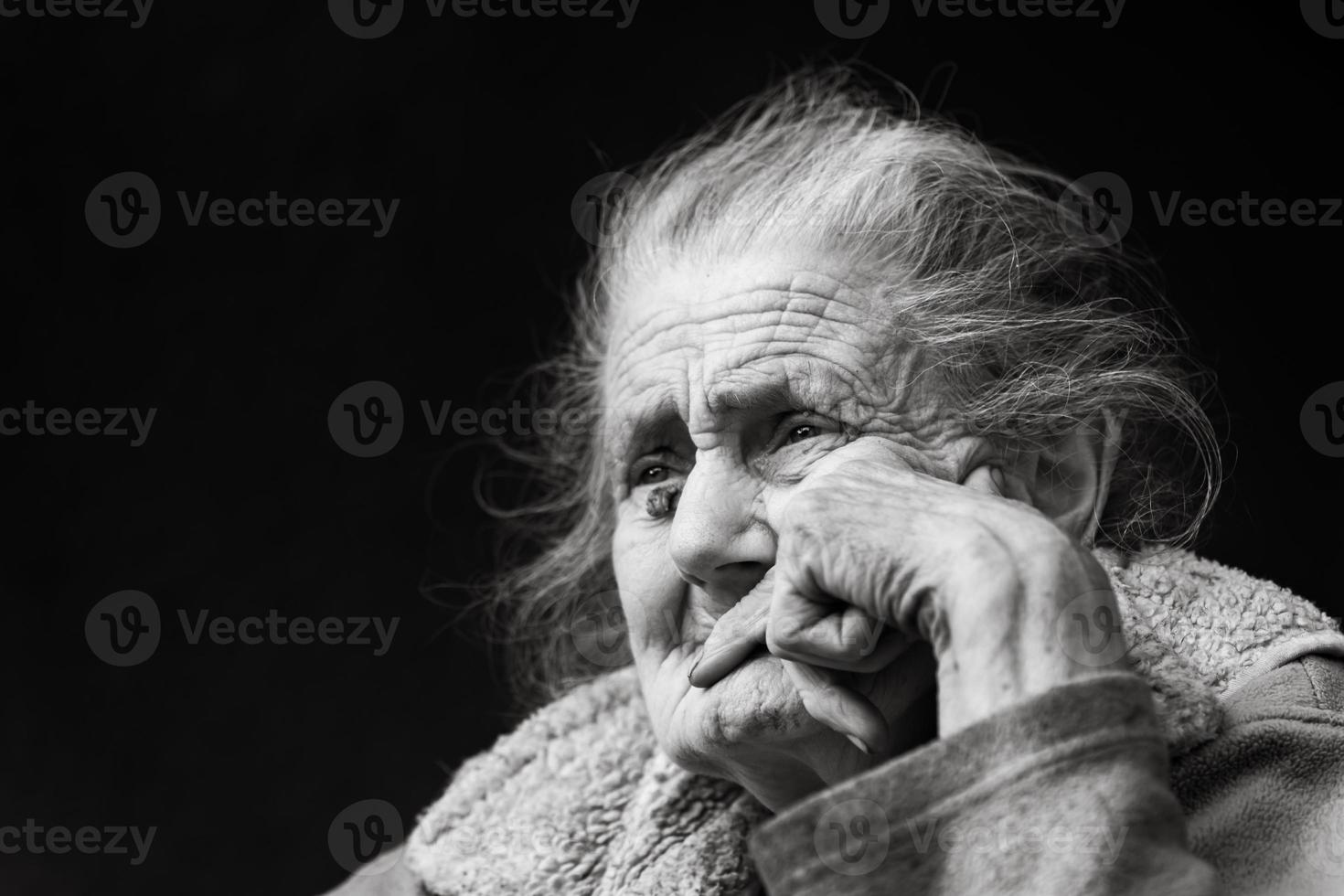 Very old and tired wrinkled woman outdoors photo