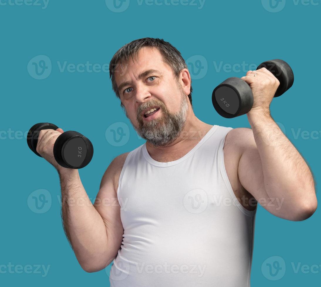 man exercising with dumbbells photo
