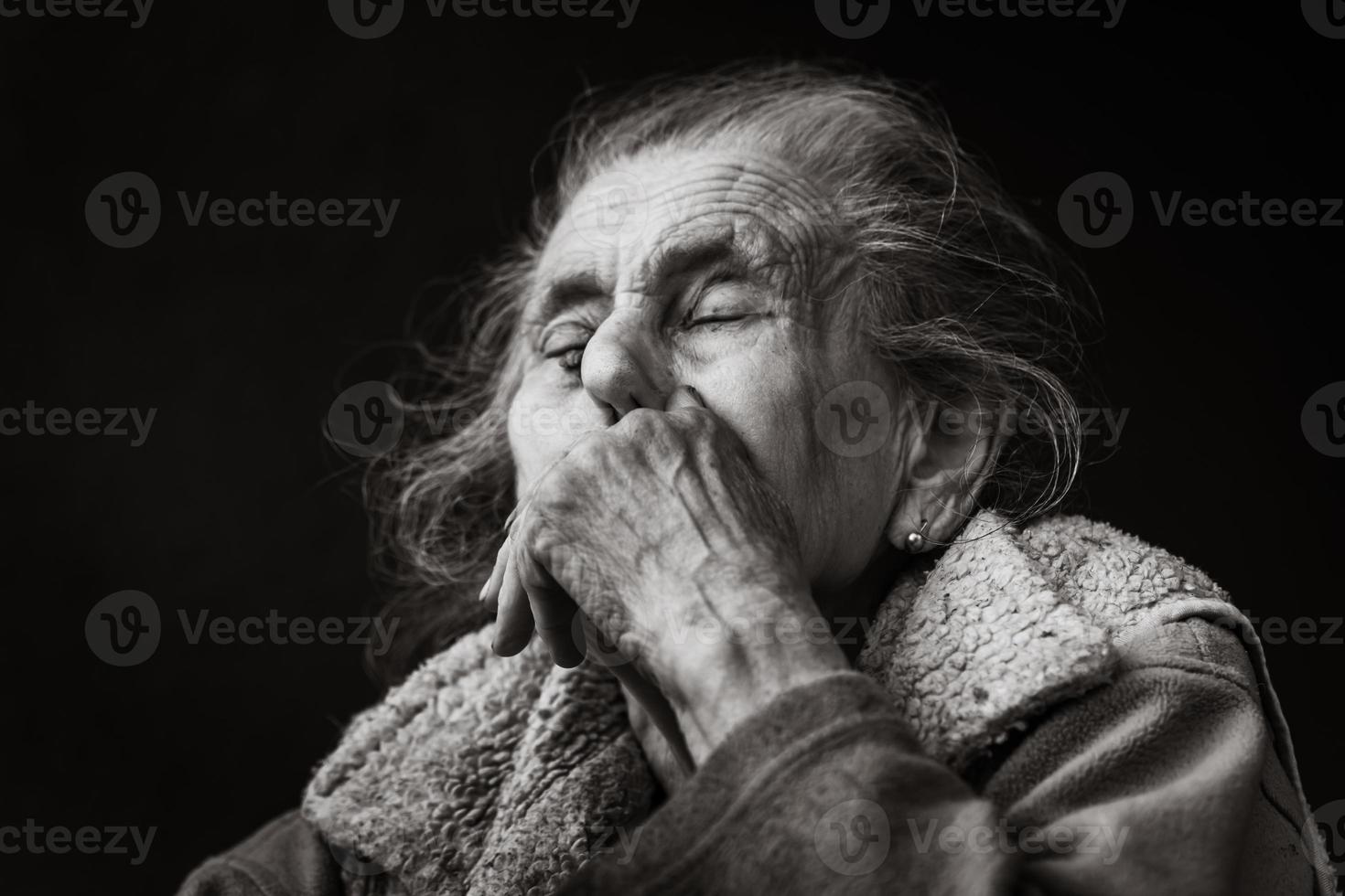 Very old and tired wrinkled woman outdoors photo