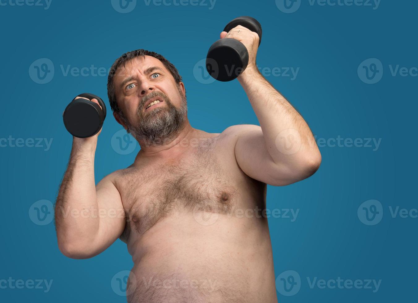 man exercising with dumbbells photo