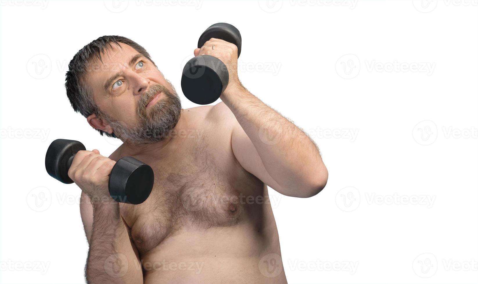 elderly fat man exercising with dumbbells photo