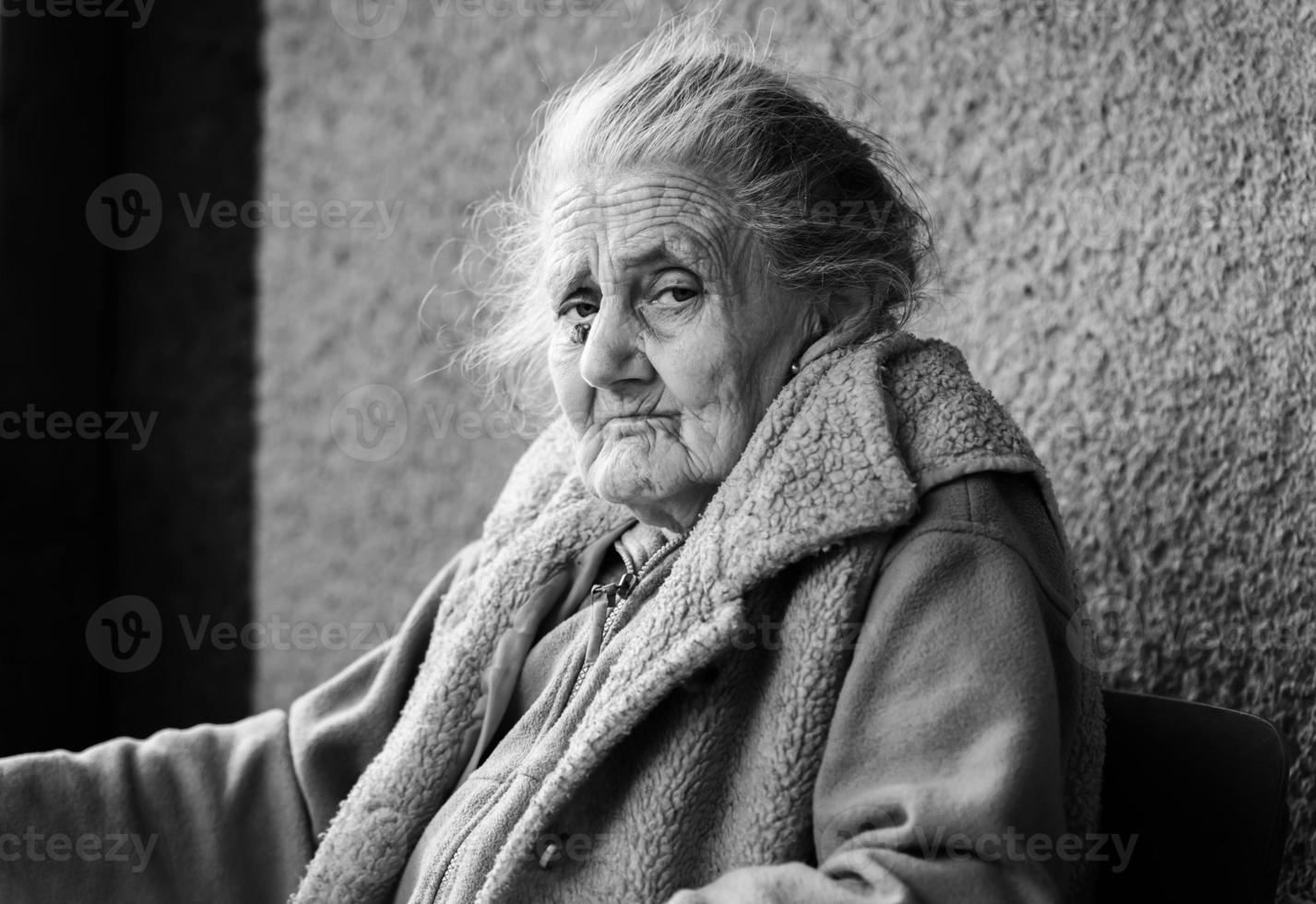 Very old and tired wrinkled woman outdoors photo