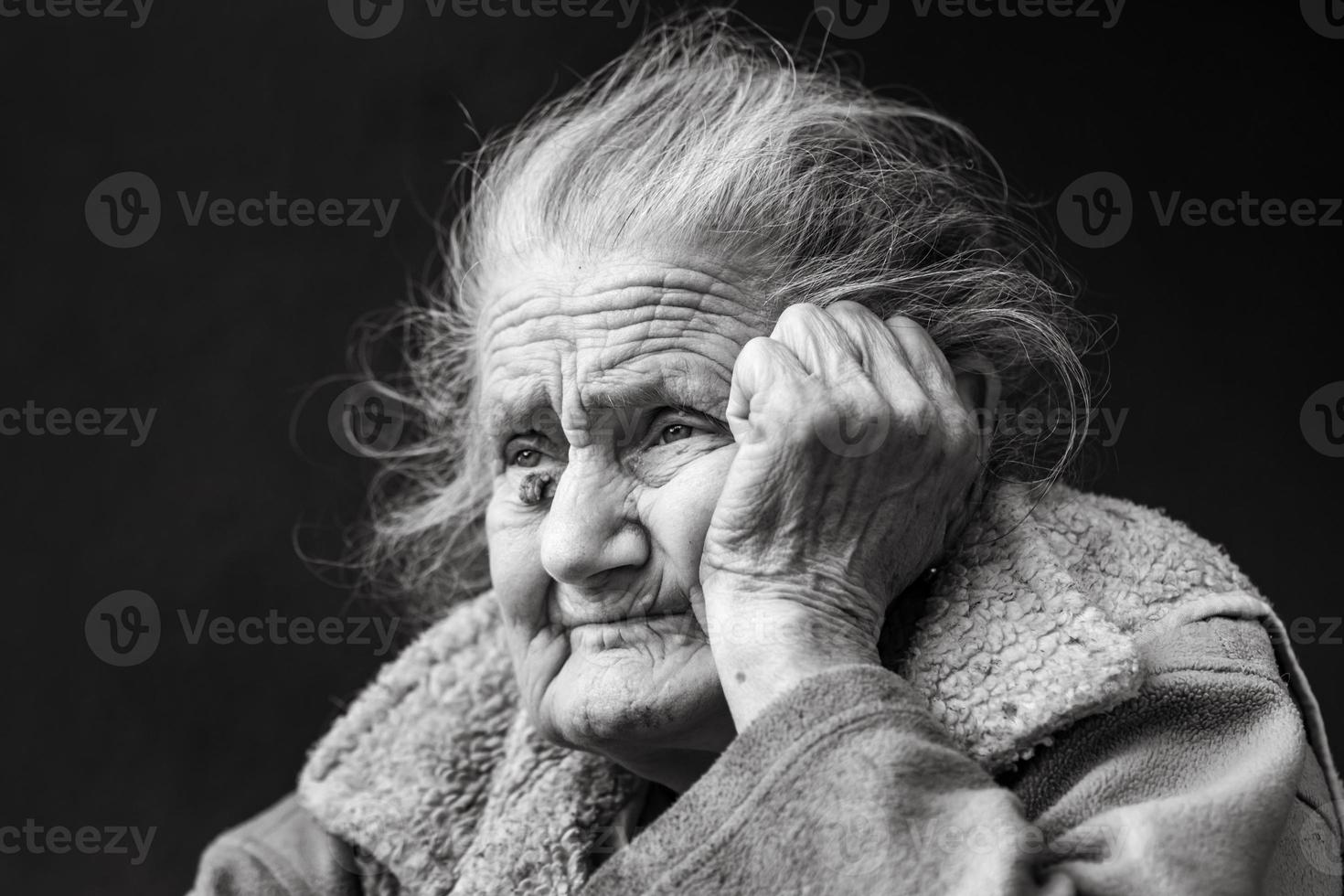 Very old and tired wrinkled woman outdoors photo