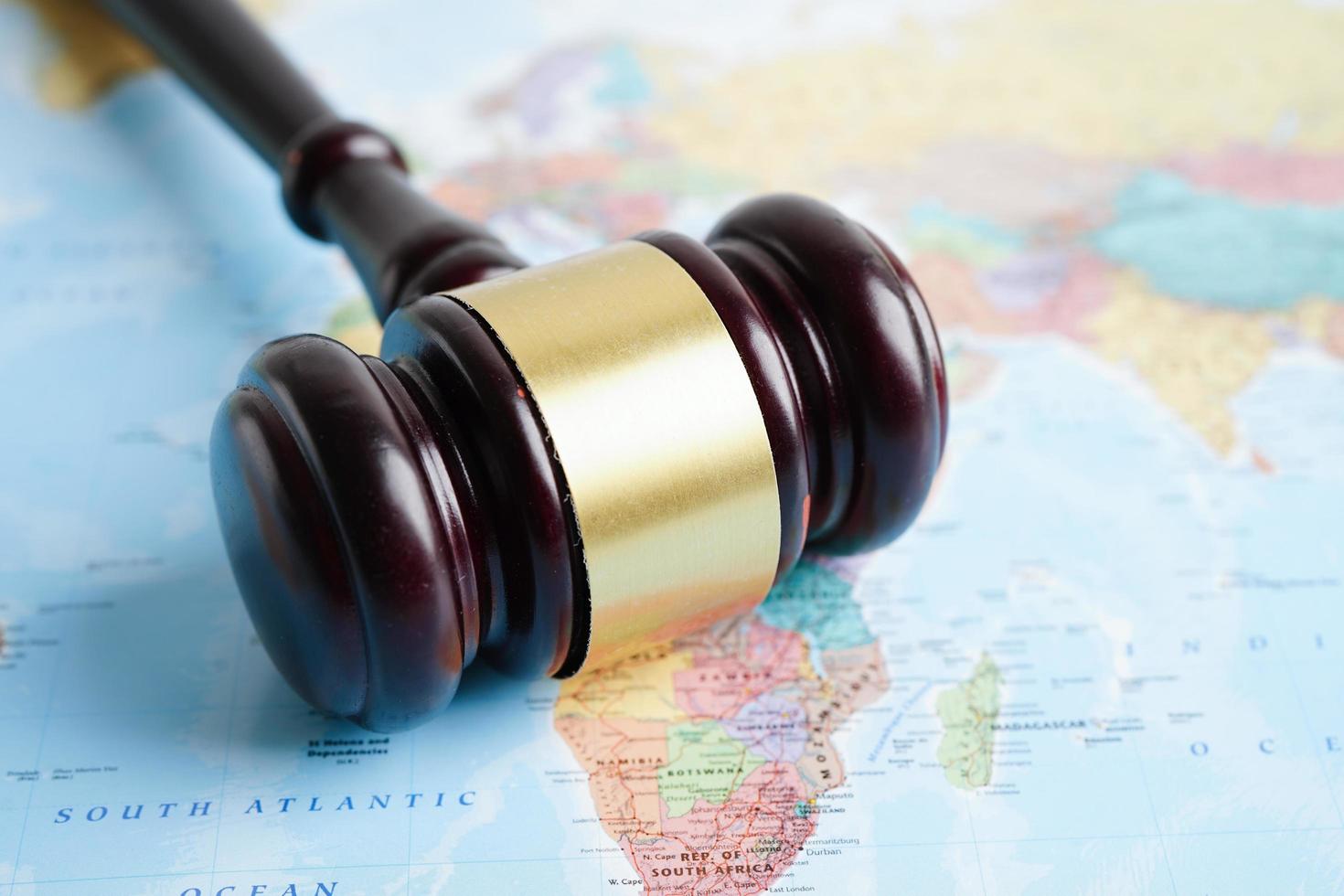 Bangkok, Thailand - May 15, 2022 Judges gavel on world map. photo