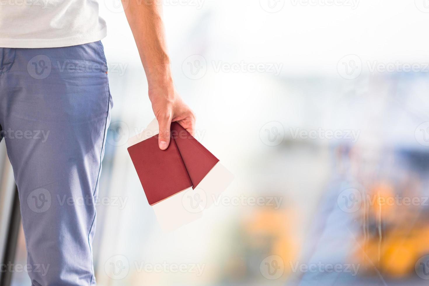 Closeup passports and boarding pass at airport indoor background airplane photo