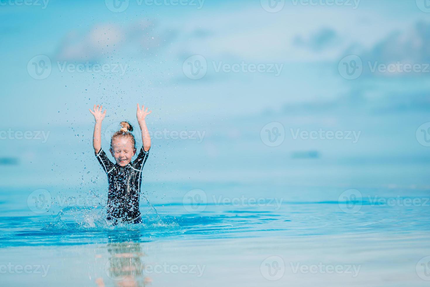 Portrait of adorable little girl at beach during summer vacation