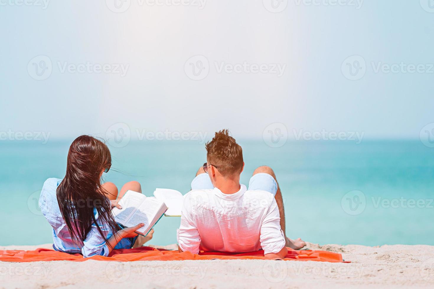 Young couple on white beach during summer vacation. photo