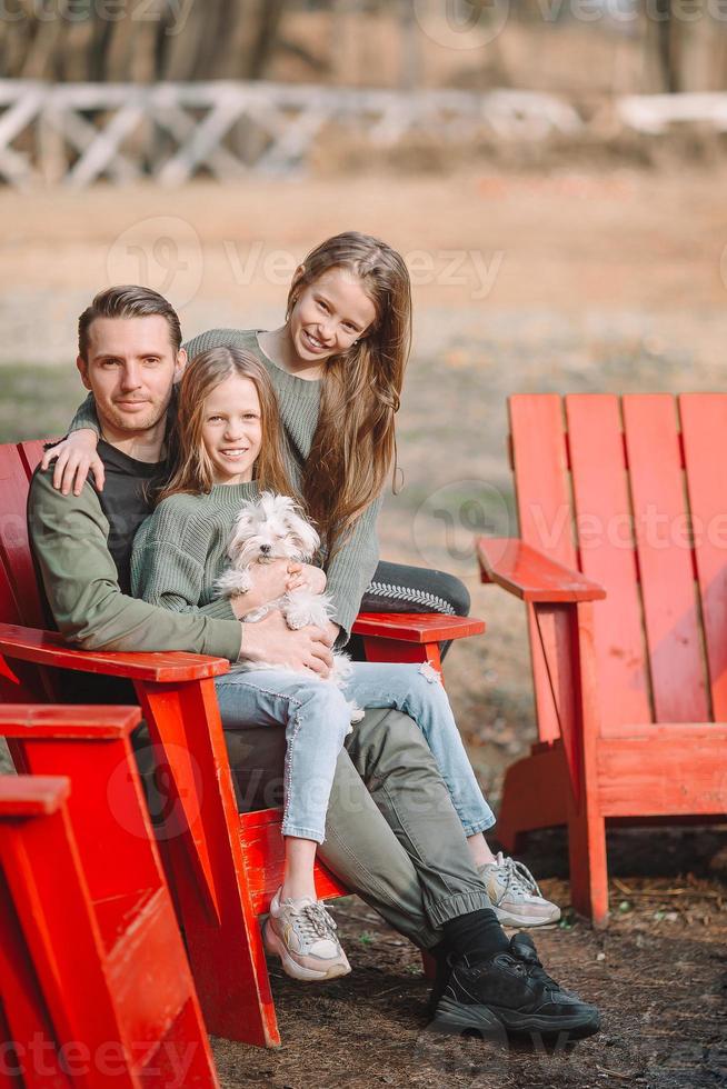 Father and cute daughters with dog outdoors photo