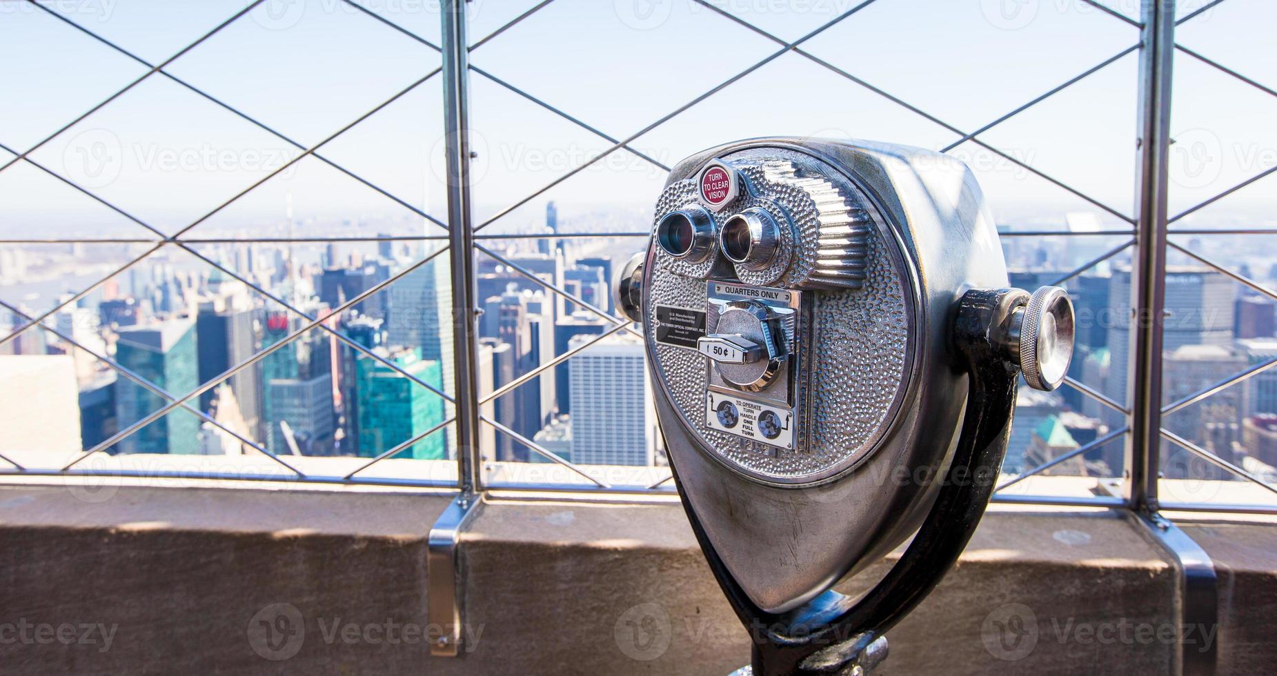 Public telescope pointed on Manhattan buildings photo