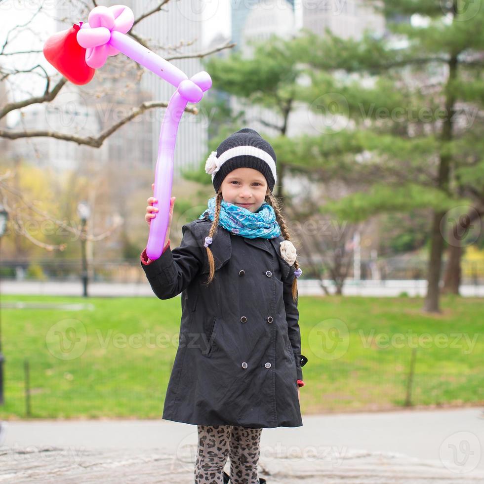 Adorable little girl with balloon in Central Park at New York City photo