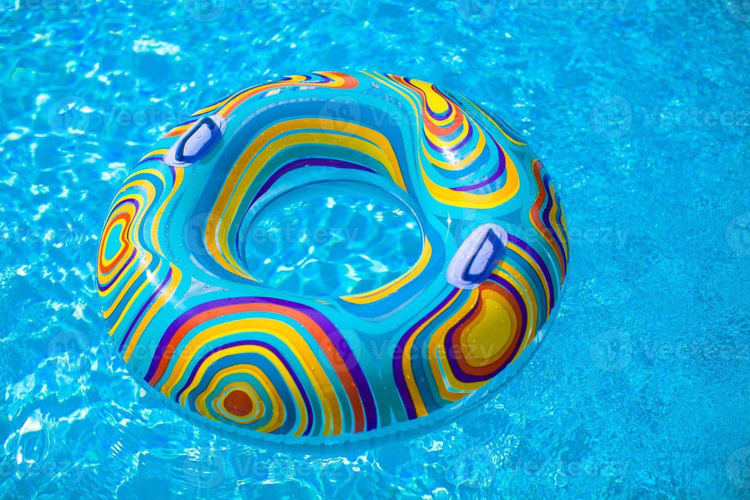 Colorful pool float in blue swimming basin photo