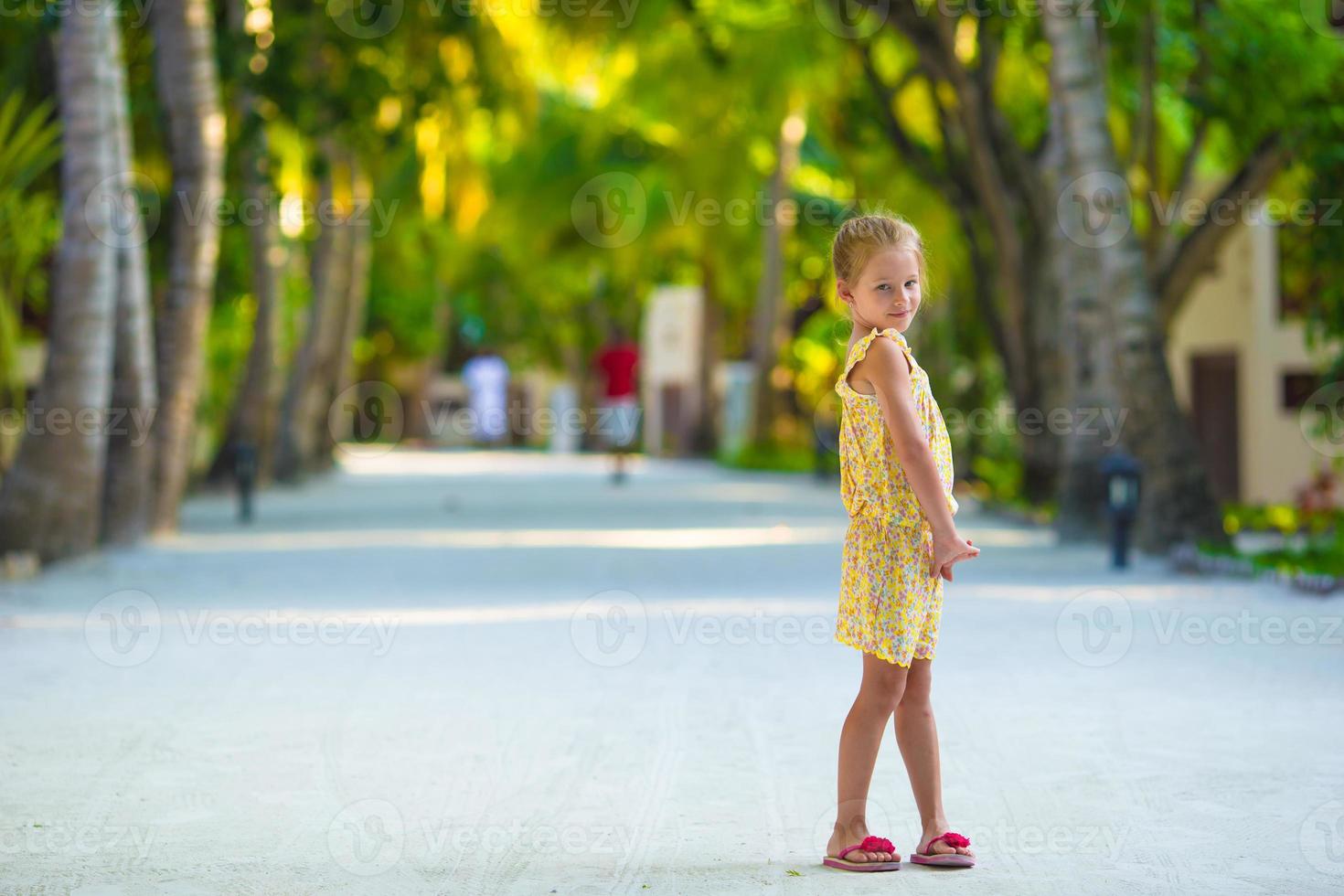 Adorable little girl during beach vacation having fun photo