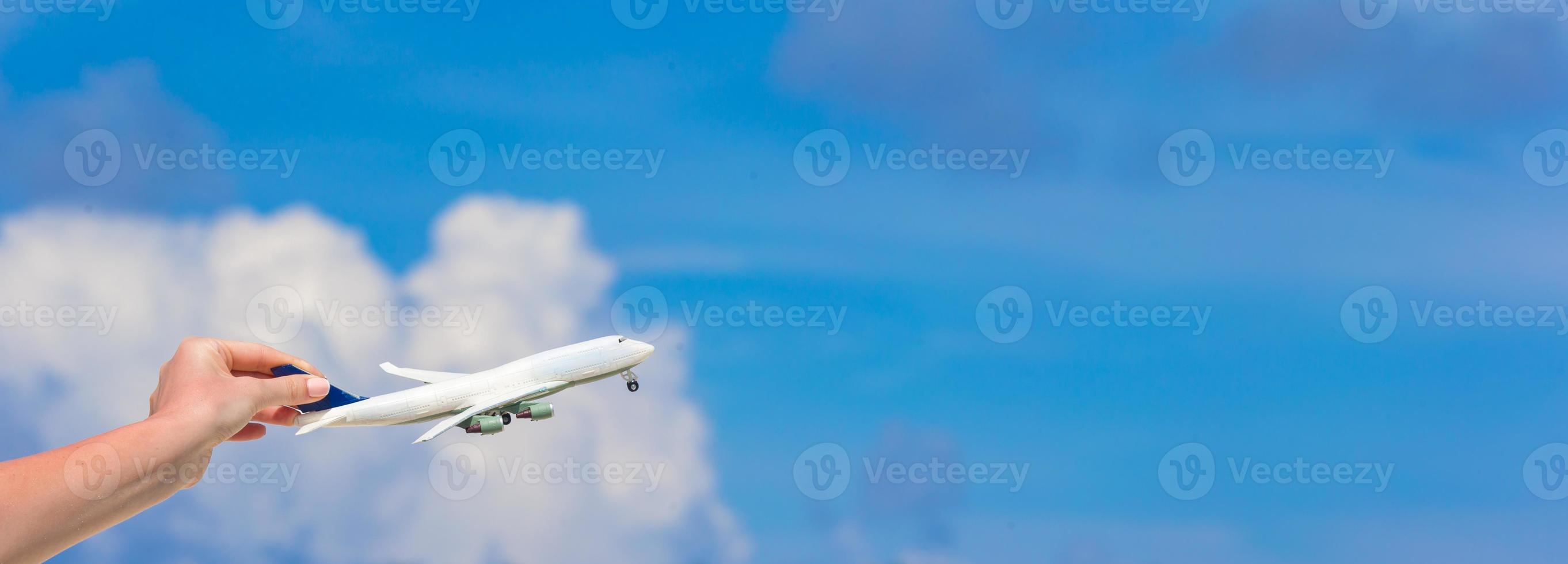 Small white miniature of an airplane on background of turquoise sea photo