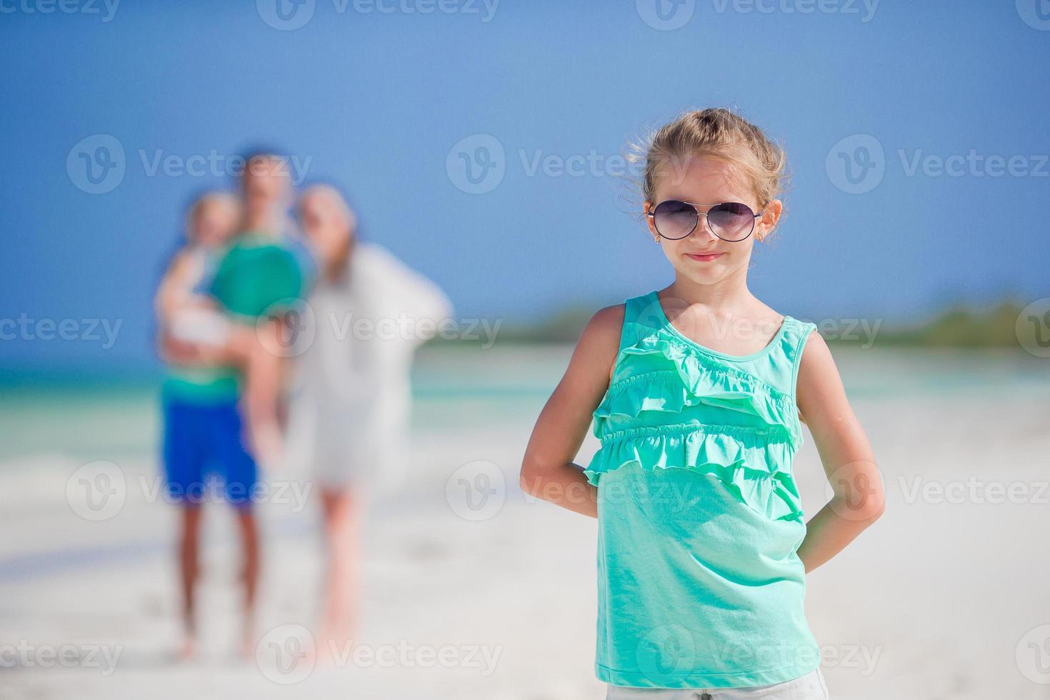 Young family on the beach. Closeup of little girl photo