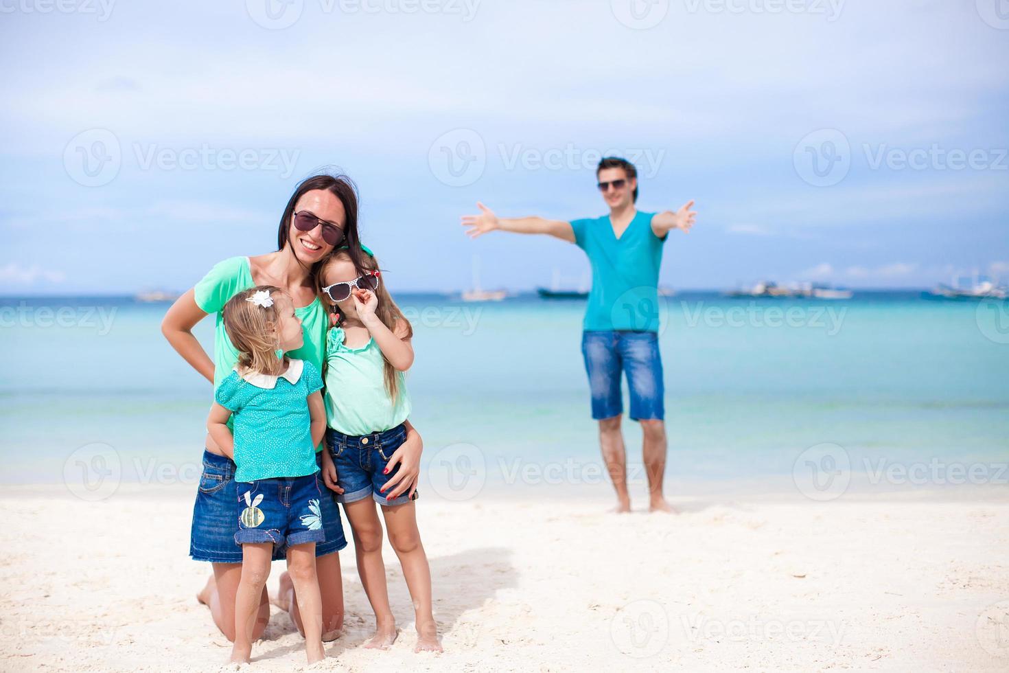 Happy family of four during summer vacation photo