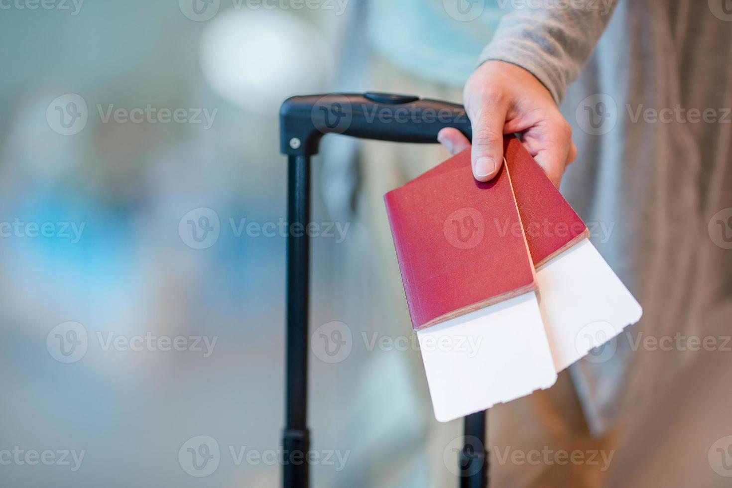 Close-up of passports and boarding pass in male hands at airport photo
