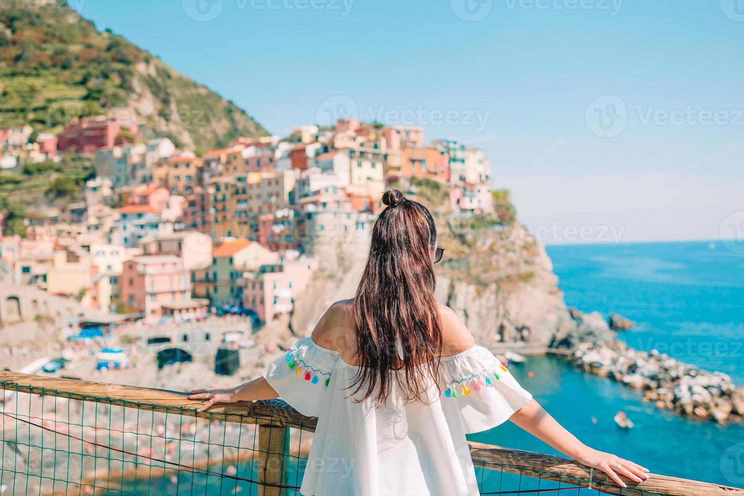 Tourist looking at scenic view of Manarola, Cinque Terre, Liguria, Italy photo