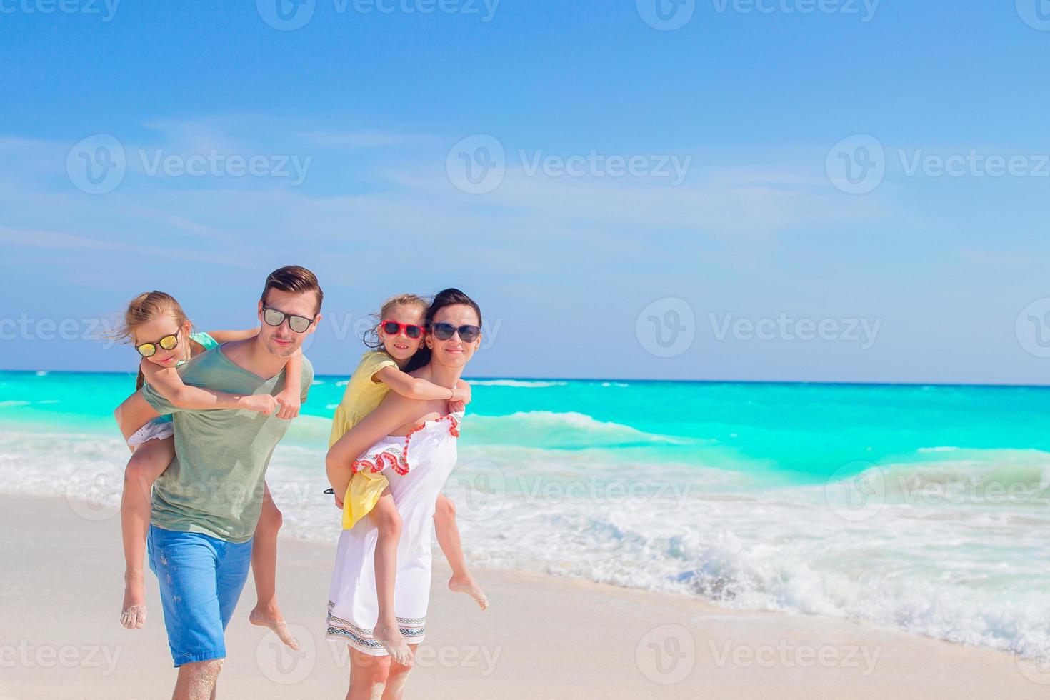 Young family on vacation have a lot of fun on the beach photo