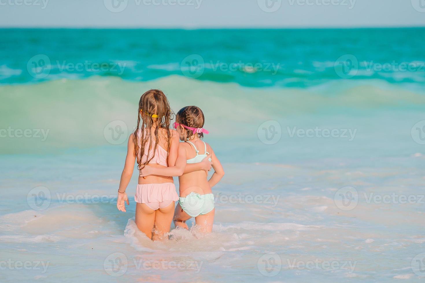 Kids have a lot of fun at tropical beach playing together photo