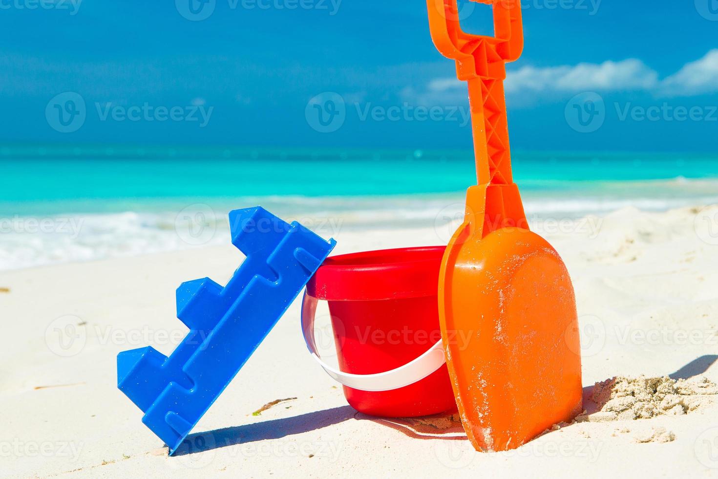 Summer kid's beach toys in the white sand photo