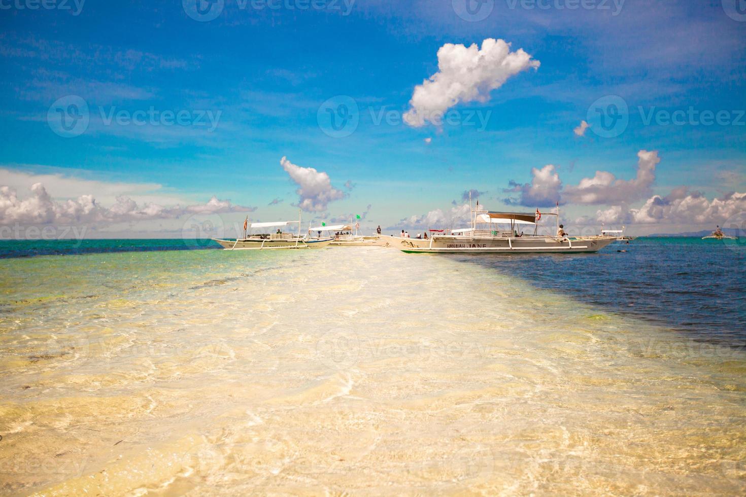 Small boats on white tropical beach photo