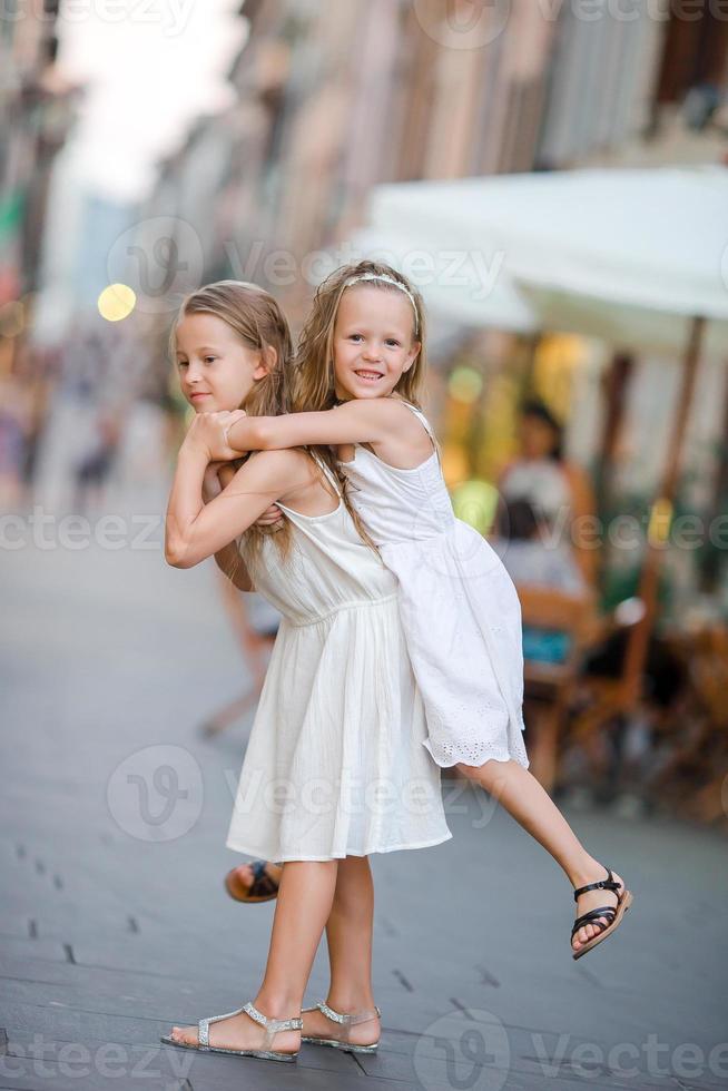 Pretty smiling little girls with shopping bags photo