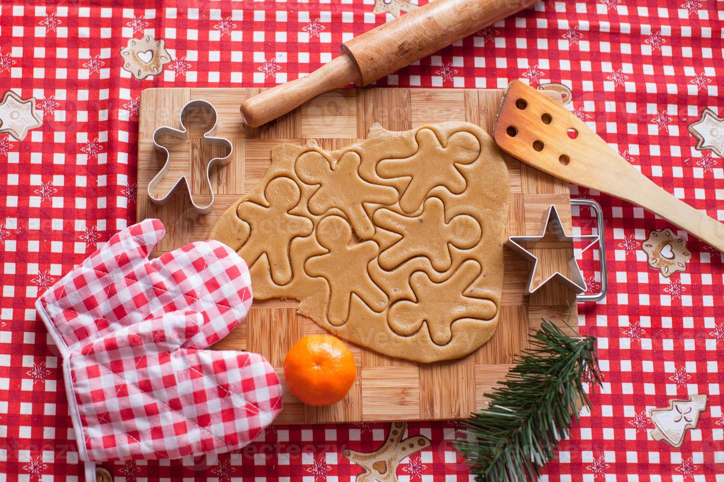 Cutting gingerbread cookie dough for Christmas photo