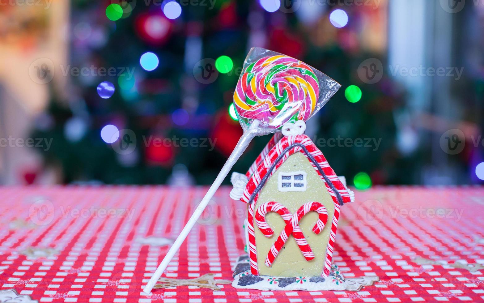 Gingerbread fairy house decorated with colorful candies of bright Christmas tree photo