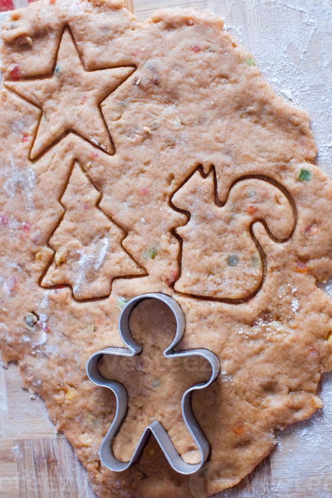 Cutting the gingerbread cookie dough for Christmas and New Year photo