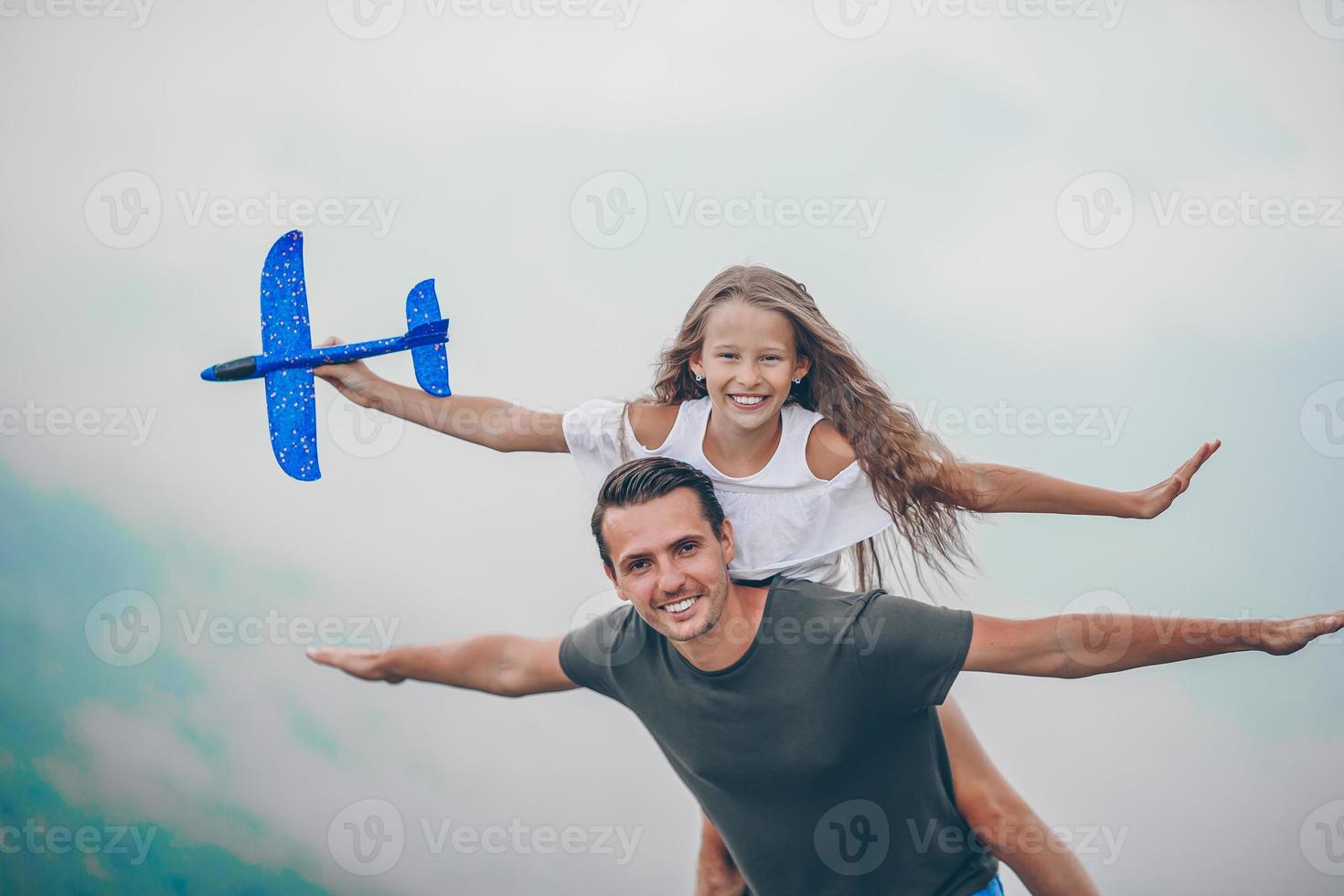 Beautiful little girl and young father in mountains in the background of fog photo